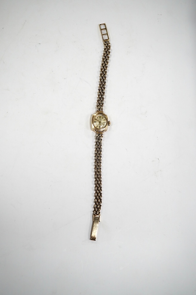 A lady's 9ct gold Accurist manual wind wrist watch, on a 9ct gold bracelet, gross weight 12.3 grams. Condition - fair